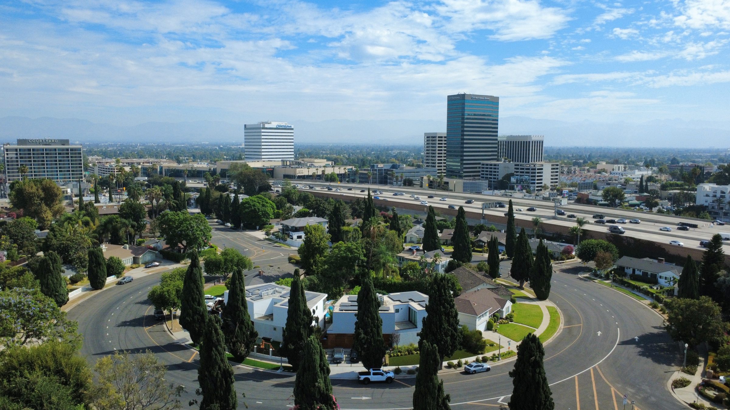 Aerial view of Sherman Oaks, the Galleria commercial towers, the 101 Freeway, and surrounding Los Angeles residential neighborhoods.
